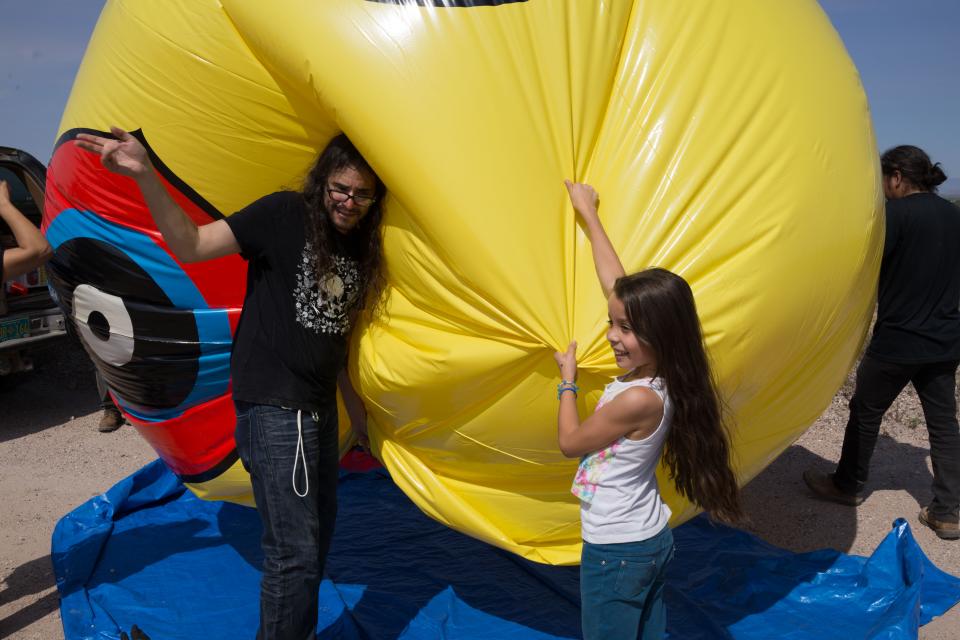 Cristobal Martinez with a deflated balloon from Repellent Fence / Photo by David Taylor provided courtesy Postcommodity
