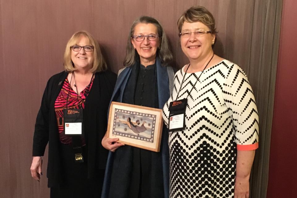 Image of Maureen Daly Goggin (left) and Shirley Rose (right) posing with Cathy Stevulak, director of 'Threads,' a documentary film shown at the conference. / Photo by Jennifer Russum