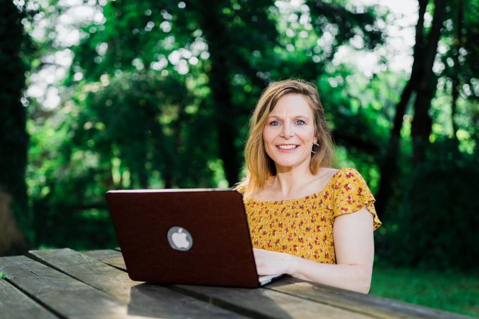 Courtesy photo of Lynn Houston at work on her computer outdoors.
