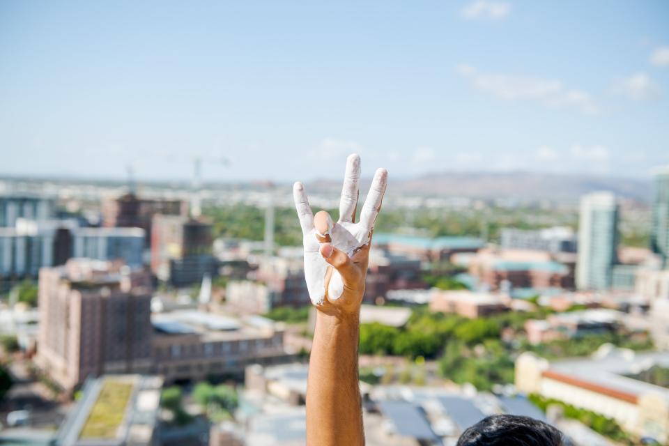 A painted hand makes the pitchfork salute / Photo by Jared Opperman