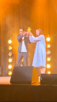 From left, graduate students Mohamed Almahdi and Ayako Hiasa hoist their Pitchfork Award at a celebration in April 2025.