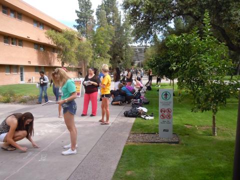 ASU News photo of sidewalk chalk art helping teach about gender and violence